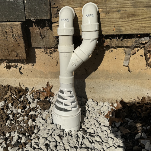 Sump pump discharge with freeze-protection adapter